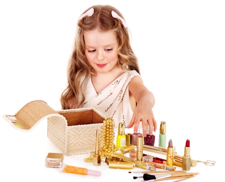 Child cosmetics. Little girl applying make up.の写真素材
