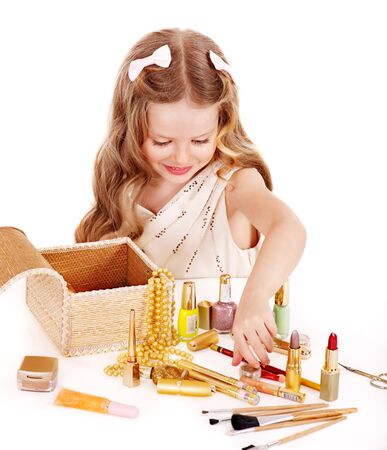  Little girl applying make up. Isolated.の写真素材