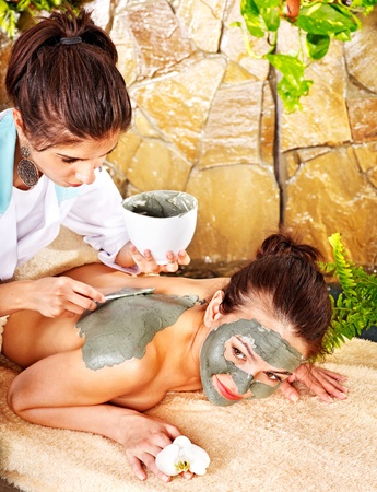 Young woman  having clay facial mask.の写真素材