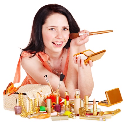 Girl applying makeup. Isolated.の写真素材