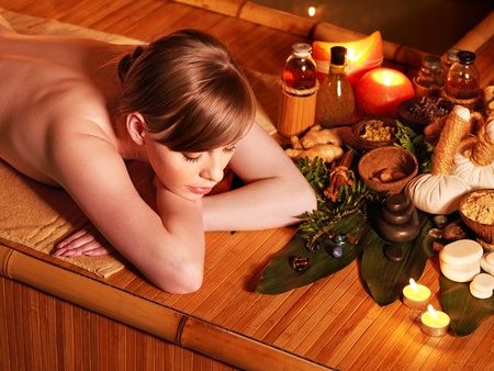 Young woman getting massage in bamboo spa.の写真素材
