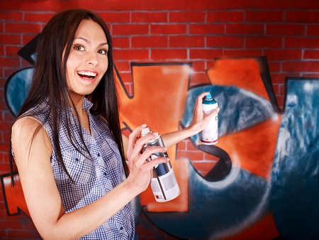 Woman with body art aganist graffiti brick wall.の写真素材