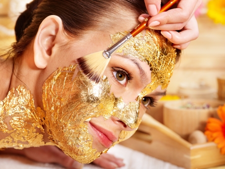 Woman getting  gold facial mask.の写真素材