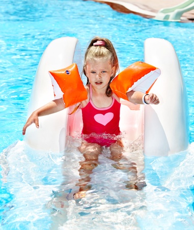 Child on water slide at aquapark. Summer outdoor.の写真素材