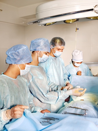 Sick patient on gurney in operating room.の写真素材