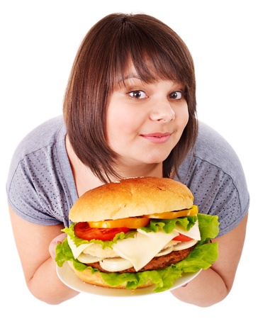 Overweight woman eating hamburger. Isolated.の写真素材