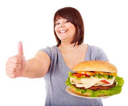 Overweight woman eating hamburger. Isolated.の写真素材