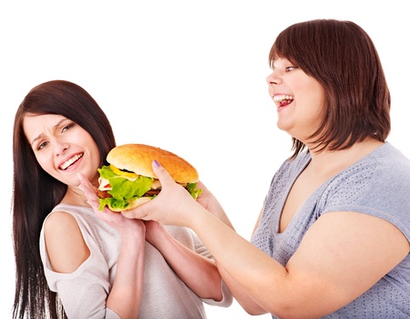 Women eating hamburger. Isolated.の写真素材