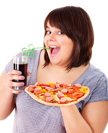Overweight woman eating fast food.の写真素材