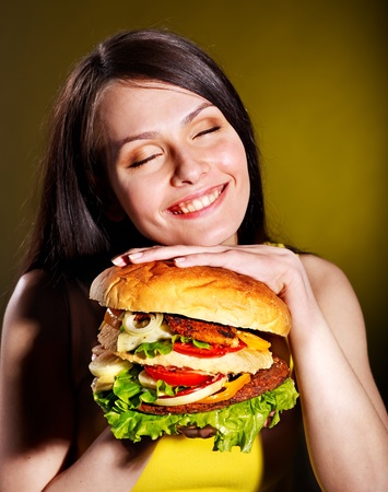 Slim woman holding hamburger.の写真素材