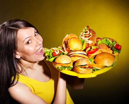 Thin woman holding group hamburger.の写真素材