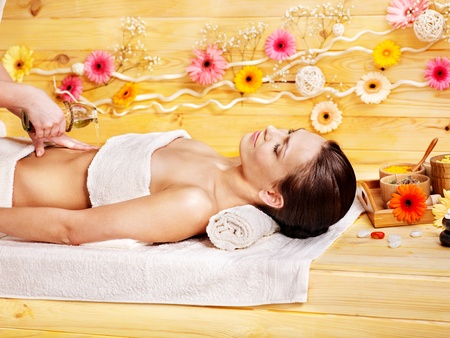 Woman getting  massage in wooden spa.の写真素材