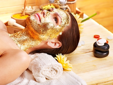Woman getting  gold facial mask.の写真素材