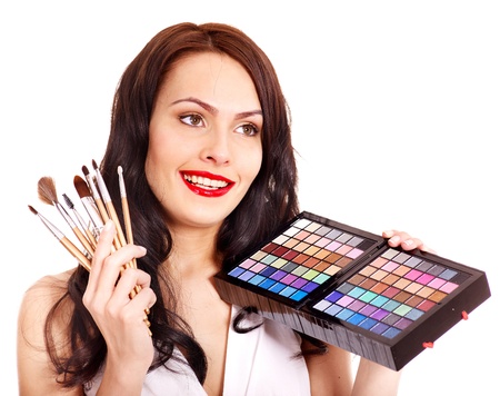 Girl holding eyeshadow and makeup brush.  Isolated.の写真素材