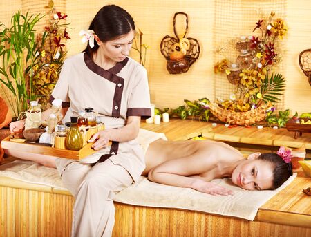 Young woman getting massage in bamboo spa.の写真素材