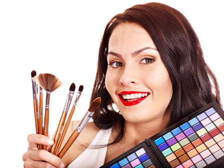 Girl holding eyeshadow and makeup brush.  Isolated.の写真素材