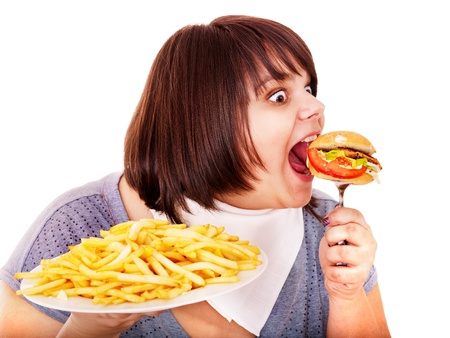 Overweight woman eating hamburger. Isolated.の写真素材