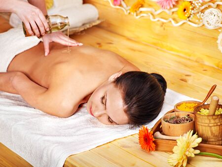 White woman getting  massage in wooden spa.の写真素材