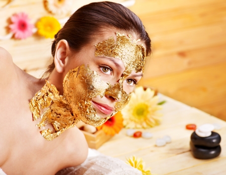 Woman getting  gold facial mask.の写真素材