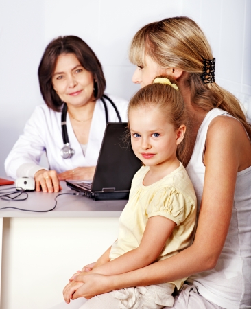 Happy family on reception at doctor.の写真素材