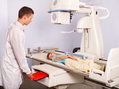 Doctor examining child patient in x-ray room.の写真素材