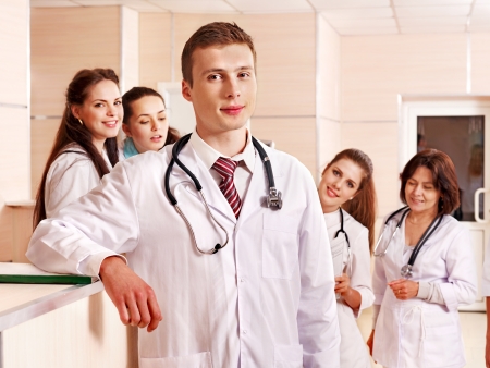 Group doctors standing at reception in hospital.の写真素材