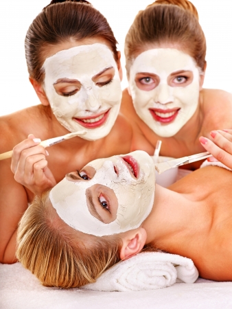 Group woman getting facial mask and gossip . Isolated.の写真素材