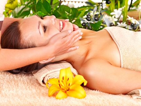 Woman getting facial massage in tropical beauty spa.の写真素材