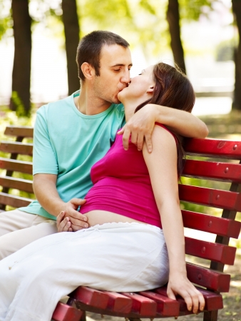 Pregnant woman with man  outdoor in park.の写真素材