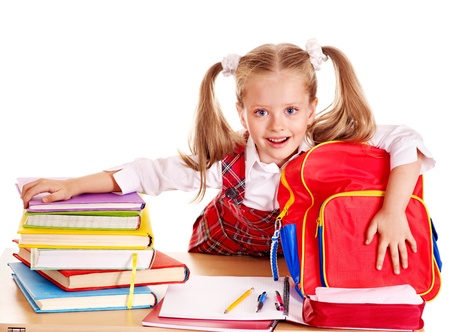 Happy little girl with school supplies and book. Isolated.の写真素材