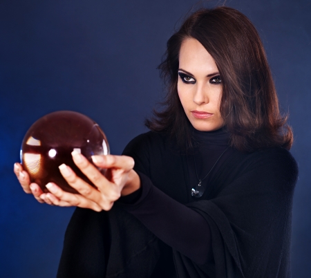 Young beautiful woman with crystal ball.の写真素材