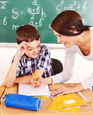 School child with teacher in classroom.の写真素材
