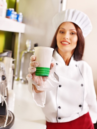 Female chef uniform at cafeteria. The focus is on the glass.の写真素材