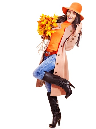 Woman wearing overcoat holding  orange leaves.の写真素材