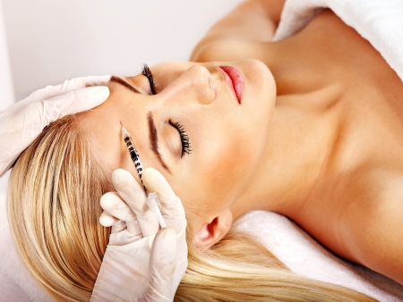 Beauty woman giving botox injections.の写真素材