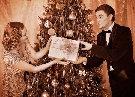 Couple on party near Christmas tree. Black and white retro.の写真素材