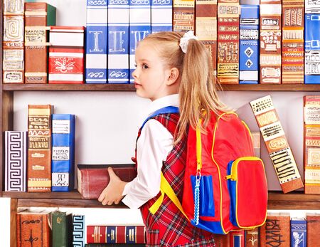Child with backpack in library.の写真素材