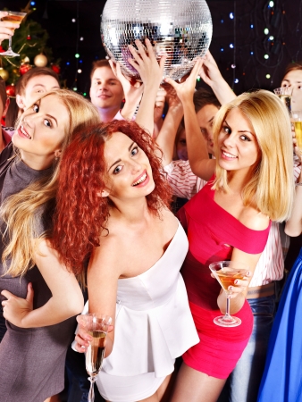 Group people with  champagne dancing at Christmas party.の写真素材