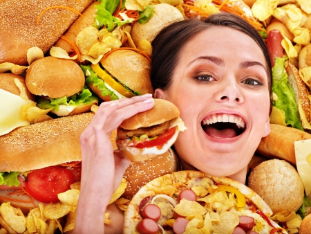 Thin woman holding hamburger.の写真素材