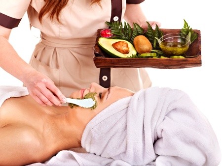 Young woman getting facial mask in spa . Isolated.の写真素材
