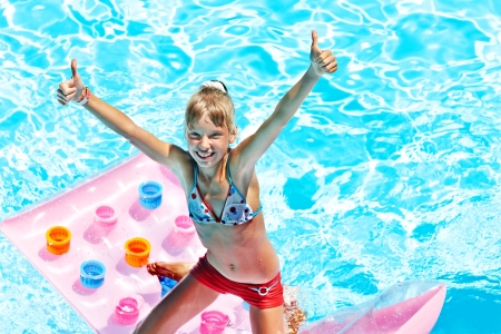 Child swimming on inflatable beach mattress.の写真素材