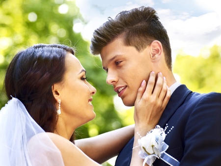 Bride and groom with flower outdoor.の写真素材