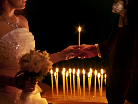 Happy wedding couple  in church. Body part.の写真素材
