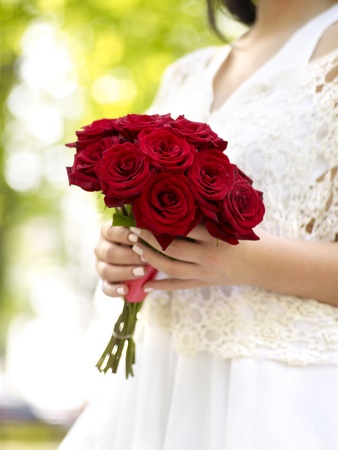 Bride with red rose bouquetの写真素材