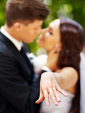 Groom kissing bride outdoor.の写真素材