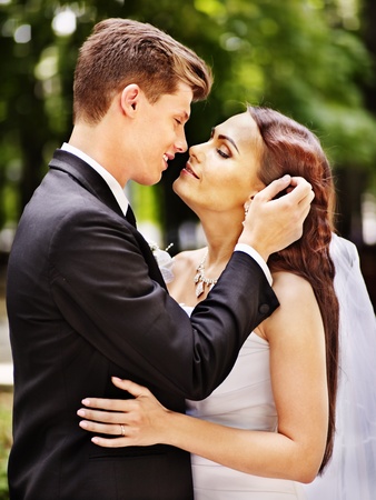 Groom embrace bride outdoor.の写真素材