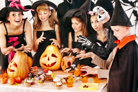 Halloween party with children holding carving pumpkinの写真素材