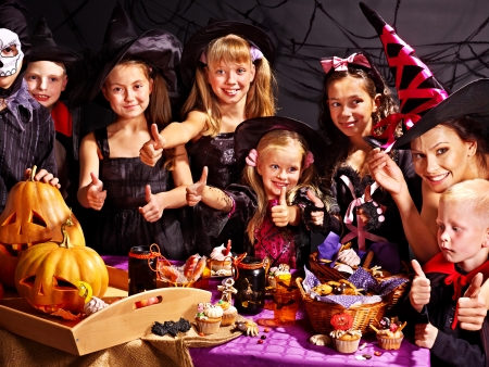 Family on Halloween party with children making carved pumpkin.の写真素材