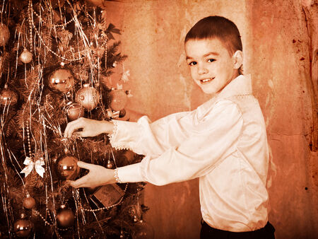 Child decorate on Christmas tree. Black and white retro.の写真素材