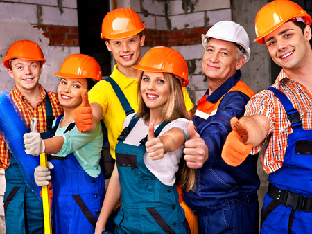Happy group people in builder uniform thumb up.の写真素材